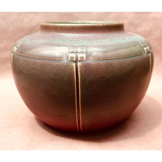 Here we have a large , bulbous , early (1913) Rookwood vase in there Native American pattern , red base with green tones...