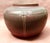 Here we have a large , bulbous , early (1913) Rookwood vase in there Native American pattern , red base with green tones...