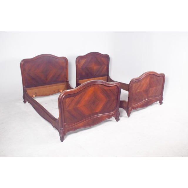 These two single beds are fine examples of French furniture in the Louis XV style, crafted from solid wood and beautifully...