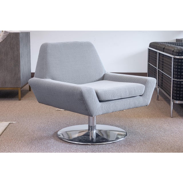 A DellaRobbia "Tech" chair and ottoman. This lovely lounge set features a fully featured swivel lounge chair and matching...