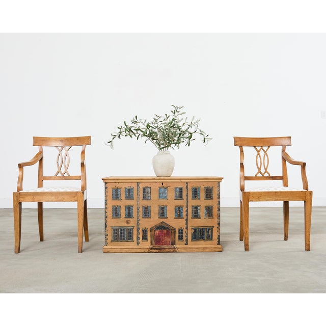 Gorgeous pair of 19th century country French provincial armchairs crafted from honey-toned fruitwood. The chairs feature a...