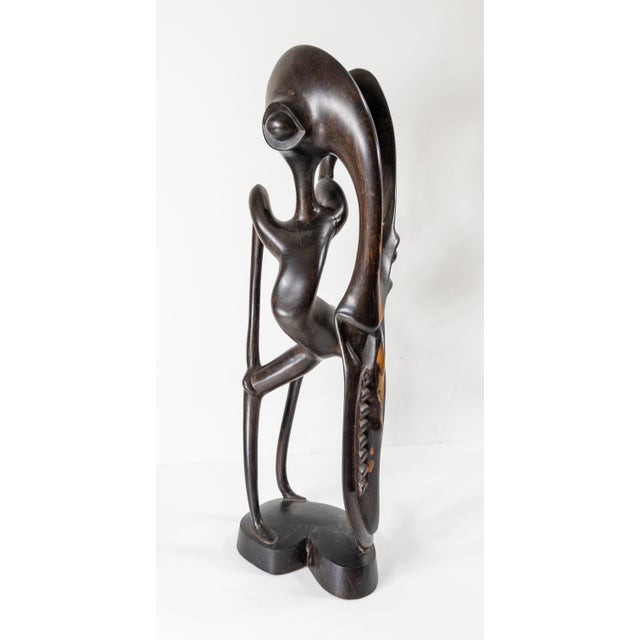 We are selling this interesting Mid-Century modern African sculpture. This sculpture has abstracted alien like figure with...