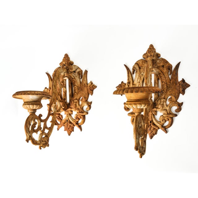 Extra large pair of cast iron wall sconce candle holder. Ornate, arms hold urn shaped pillar candle holders. Each measures...