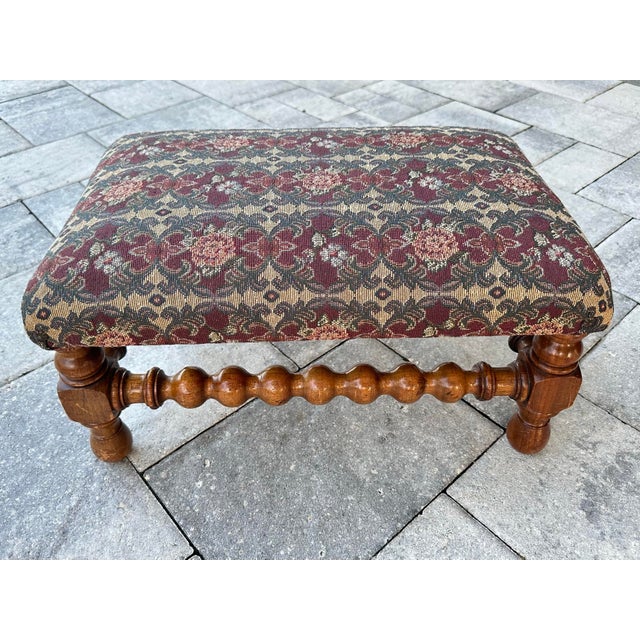 Antique solid wood stool with cushioned tapestry top and bobbin turned legs. Tapestry is a colorful green, red & pink...
