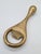 An elegant, vintage bottle opener made of solid brass, featuring the modernist aesthetic characteristic of mid-century...