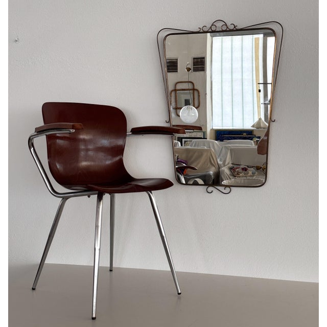 Beautiful and elegant large wall mirror with brass frame and decorations. Made in Italy in the 1950s. The brass frame have...