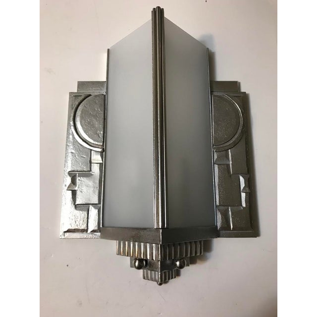 Gorgeous pair of French Art Deco geometric cubist wall sconce. With four frosted glass panels. Having intricate geometric...