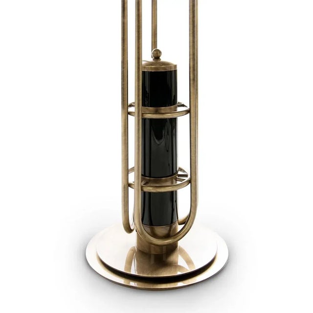 Neil floor lamp is a reminiscent lamp of the golden years of space. Around, brass base secures a black matte stem reaching...