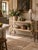 An antique French garden table featuring a two-tier design and a painted iron base with delicate scrollwork. The plank...