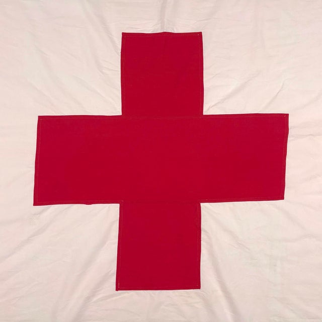 This vintage flag is made from a thin cotton cloth (similar to a bedsheet), with a pale pinkish cast likely due to...