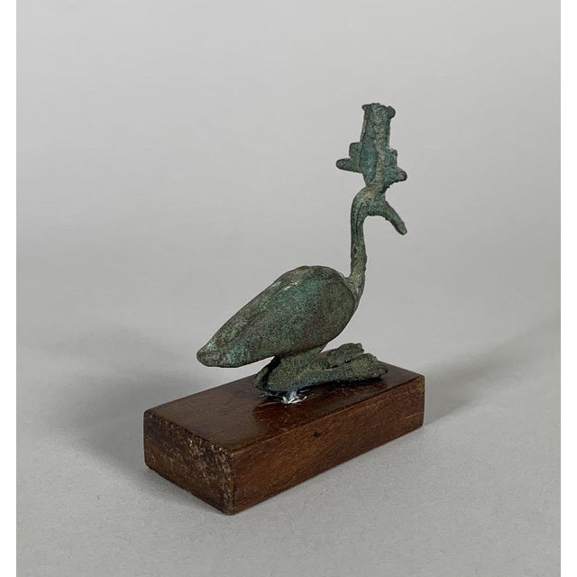 Bronze statuette of Thoth-Ibis with a green patina, Egypt, Ptolemaic period, 332–30 BC. This bronze statuette depicts a...