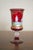 A decorative Murano ruby red glass chalice, attributed to Salviati, featuring hand-painted enamel decoration with...