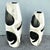 Smaller: 10.5”w, 25”h A striking pair of Postmodern tessellated stone floor vases showcasing bold abstract inlaid designs...