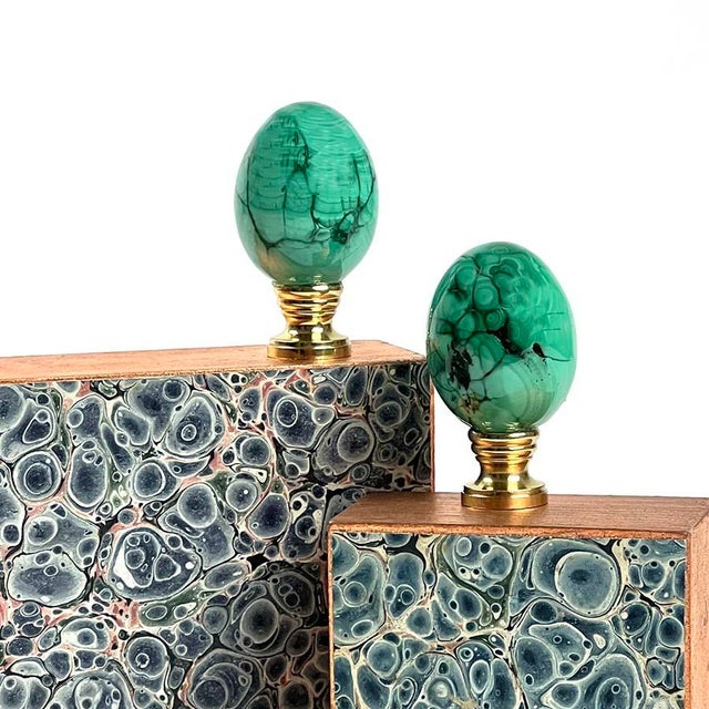 Pair of Malachite eggs mounted on brass bases. Measuring 2.5″ tall.