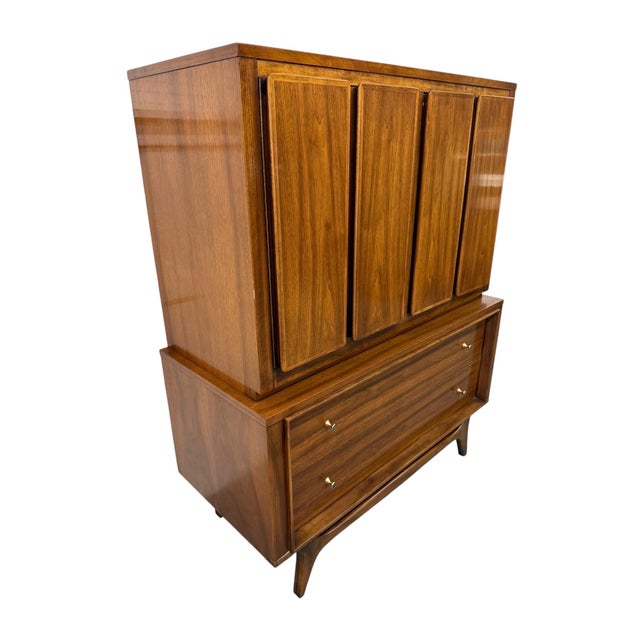 Stunning Mid-Century Modern walnut high chest from the highly desirable Insignia collection by Kent Coffey, dating to the...