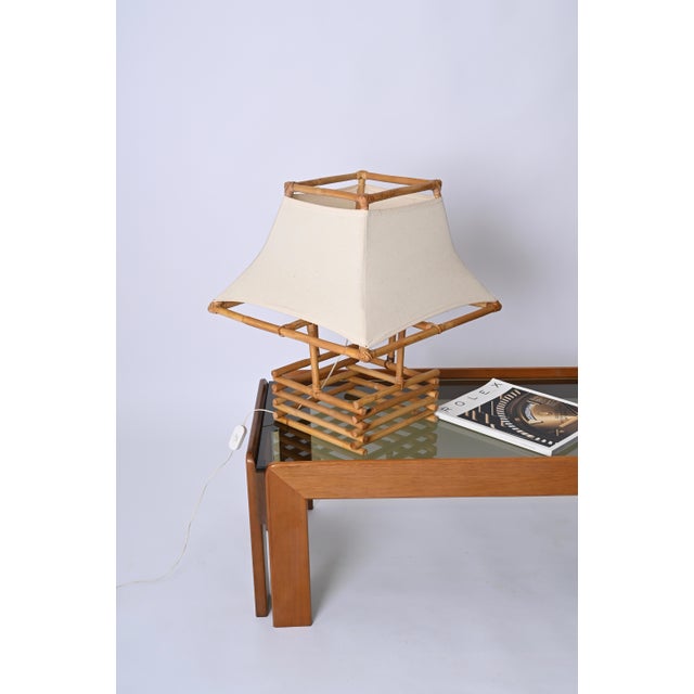 Fantastic large midcentury table lamp in rattan, bamboo and fabric. This lovely piece was made in France in the 1960s and...