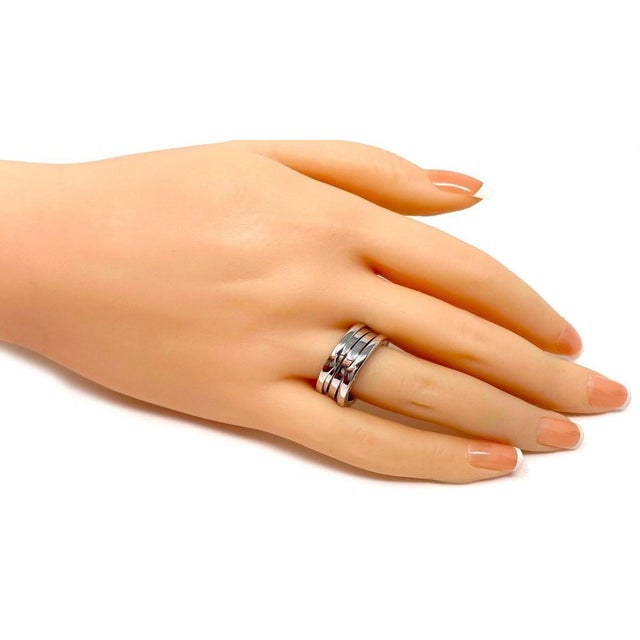 This authentic Bvlgari B.zero1 Three-Band Ring is a sophisticated and timeless piece crafted in 18k white gold with a...