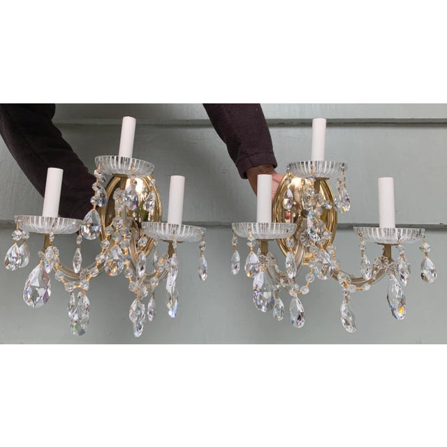 Pair of vintage polished brass sconces with crystal drops. Formally hung in the Southern California estate used in the...
