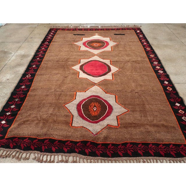 This piece features a wool pile of symmetric knots on a wool foundation. Three bold ecru octagrams march up the center of...