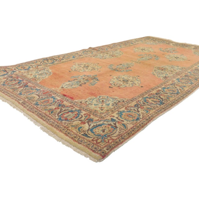 75204 Vintage Persian Tabriz Rug, 04'00 X 07'07. This hand-knotted wool vintage Tabriz rug features beautiful vase motifs...