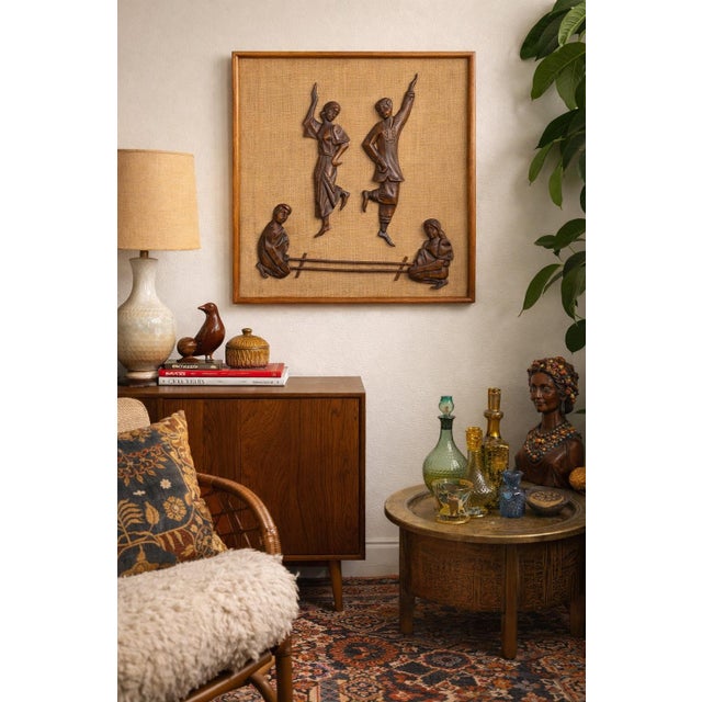 A striking vintage Philippine handcrafted wall relief featuring four folk figures rendered in dimensional hand-carved...