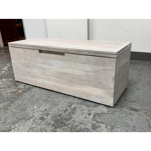 Design Plus Gallery presents an Acacia Storage Bench from CB2. This solid acacia bench does double duty as extra seating...