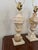 A pair of vintage marble lamp bases. Beautifully carved on pedestals. The lamps come with harps and finials. No shades...