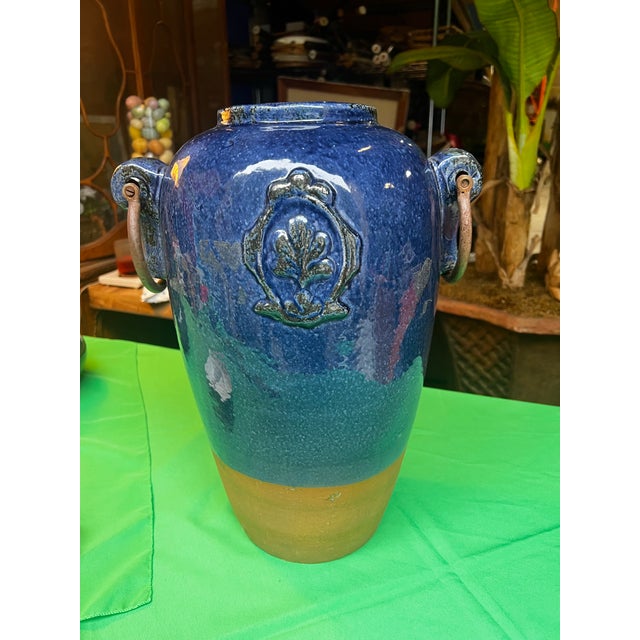 Up for consideration is a beautiful vintage blue ceramic large vase with metal ears. This would look lovely in your home...