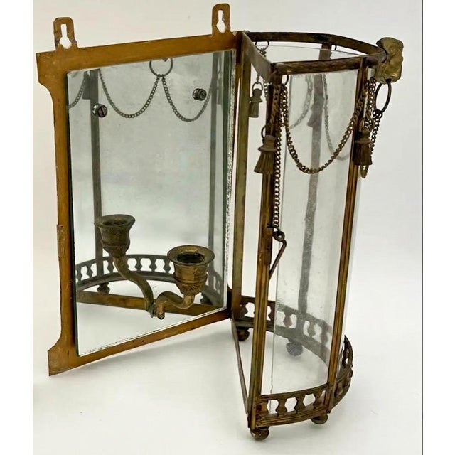 These are French Napoleonic sconces with draping tassels and lion masque. They date to approximately 1850. The curved...