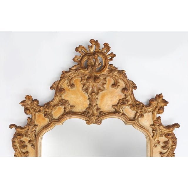Stunning rococo or baroque mirror in gilted resin, made in Belgium in the 1950s. The ornate design of the frame features...