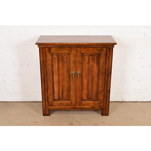 A gorgeous French Louis Philippe style flip top server or bar cabinet By Baker Furniture USA, 1980s Carved walnut, with...