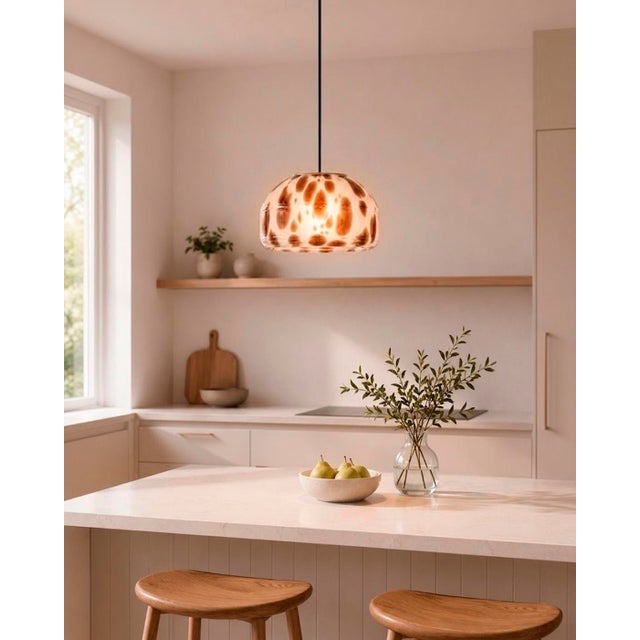 Crafted with high visual clarity, this modern pendant lamp features a sleek silhouette hand-blown from premium glass in a...