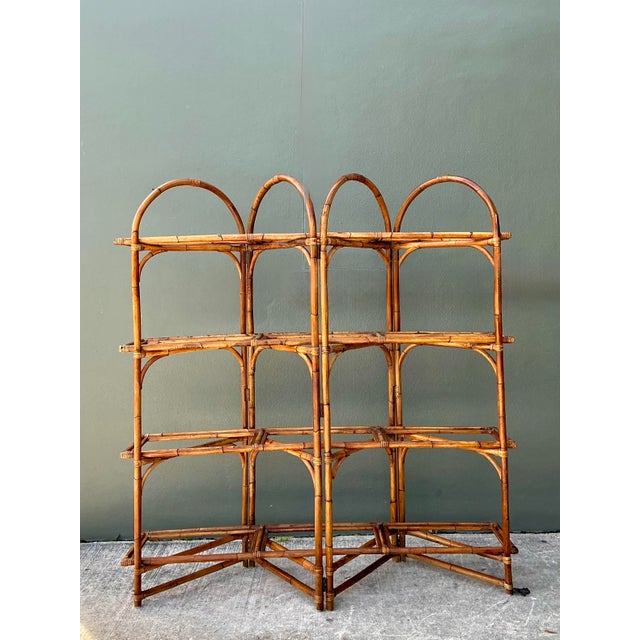 Infuse your space with a touch of organic warmth and bohemian charm with this striking vintage bent rattan etagere....