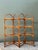 Infuse your space with a touch of organic warmth and bohemian charm with this striking vintage bent rattan etagere....