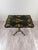 An elegant 19th-century folding table in the Napoleon III style, crafted from black lacquered wood and richly decorated...