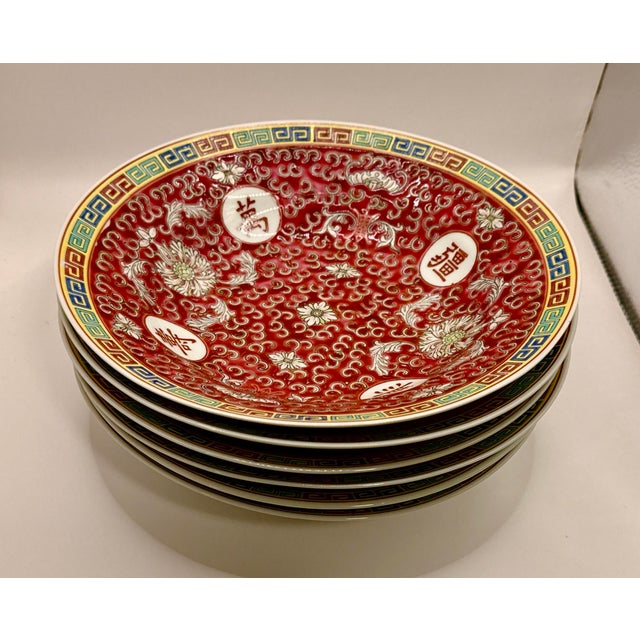 Six (6) Vintage Chinese Mun Shou Bowls. These large bowls, measuring 9” wide x 2” tall, are characterized by a vibrant red...