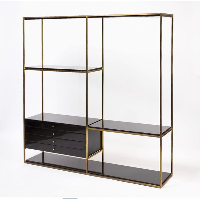 A beautiful lacquered enamel wood and brass shelving unit or room divider by Paul Mccobb for Calvin for the Irwin...