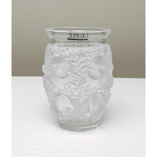 Authentic Lalique “Bagatelle” frosted crystal vase, featuring the iconic motif of lovebirds nestled among lush, flowing...