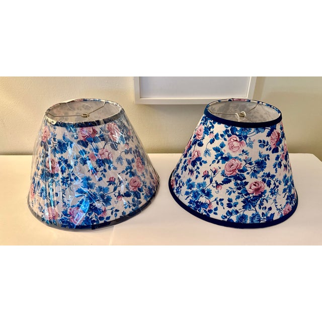 A beautifully made pair of new, unused floral fabric lampshades featuring a classic cottage‑style print in soft pinks and...