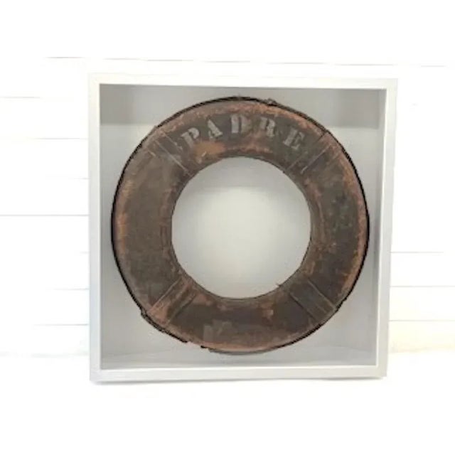 Vintage Orange Lettered "PADRE" Life Ring. The aging of this item just adds more interest to the piece. Framed 36x5x36....