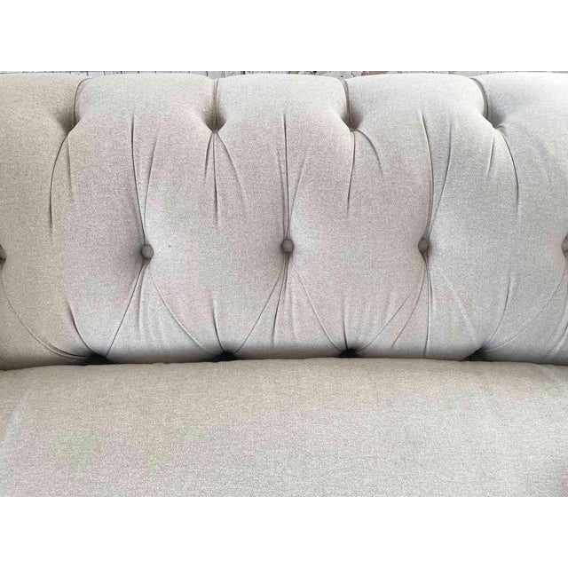 Vintage ‘Roger & Chris' light gray upholstered roll arm sofa with tufted back. Wool felt upholstery. Muffin top rolled...