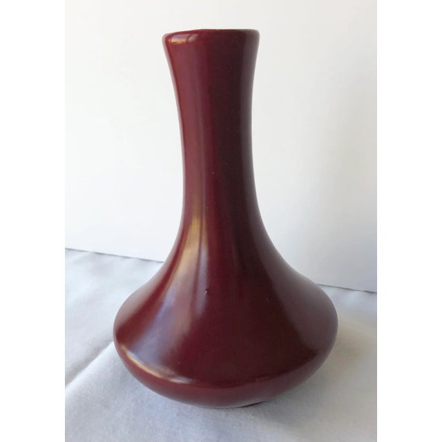Royal Haeger oxblood bud vase with a low sheen finish, although not completely matte, and a simple and elegant Art Deco form.