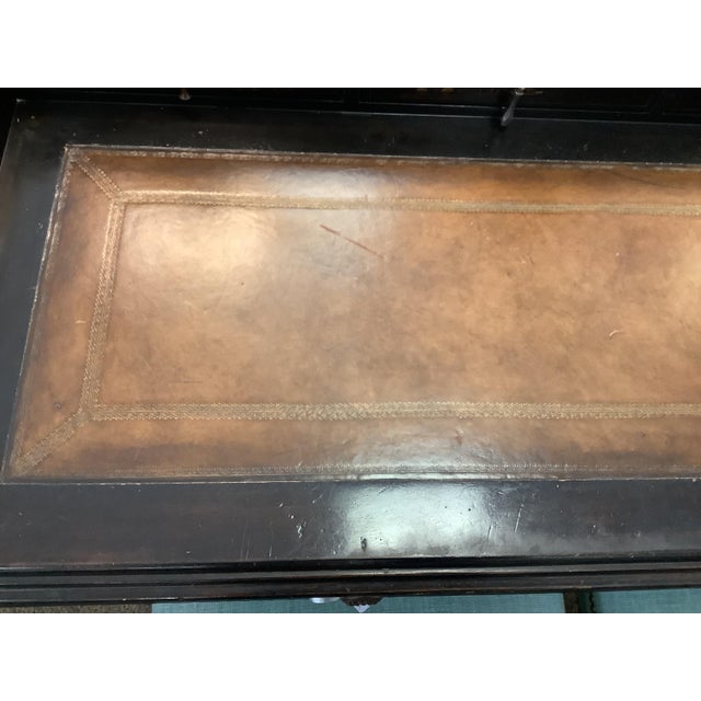 Black Chinoiserie writing desk. Embossed Brown leather top. Multiple drawers. 2 large, 4 small.