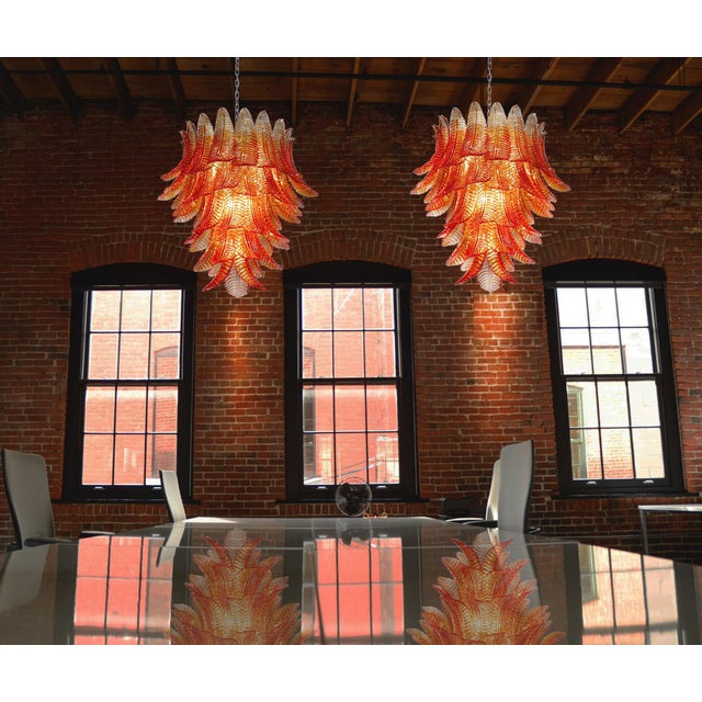 Beautiful and huge pair of Italian Murano chandeliers each composed of 52 splendid amber glasses that give a very elegant...
