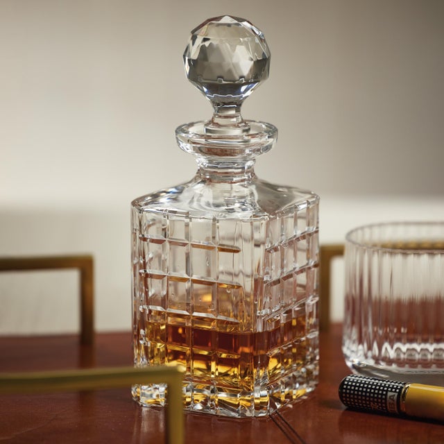 Impress your guests with the stunning Crystal Glass Decanter. Crafted from high-quality glass, this decanter features a...