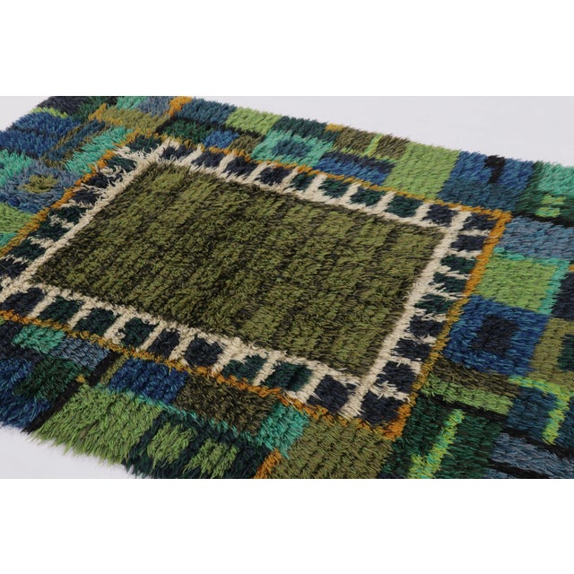 Hand-knotted in lush, high-pile wool in Sweden circa 1960-1970, this 5x6 vintage Swedish Rya rug is a bold new addition to...