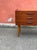 An original teak chest of drawers in the Mid-Century Modern (MCM) style. It features three spacious drawers with milled...