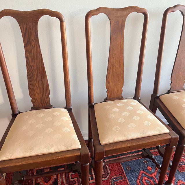 A beautiful set of four early 20th century classic Georgian / Queen Anne style dining chairs featuring elegant shield-form...