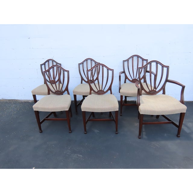 This classic Set of Dining Table, Six Chairs and 2 Leaves is made out of wood, mahogany, veneer, and upholstery. The set...