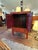 Large striking red and gold Chinoiserie cabinet having two doors that open to storage within. No shelf but there is a...